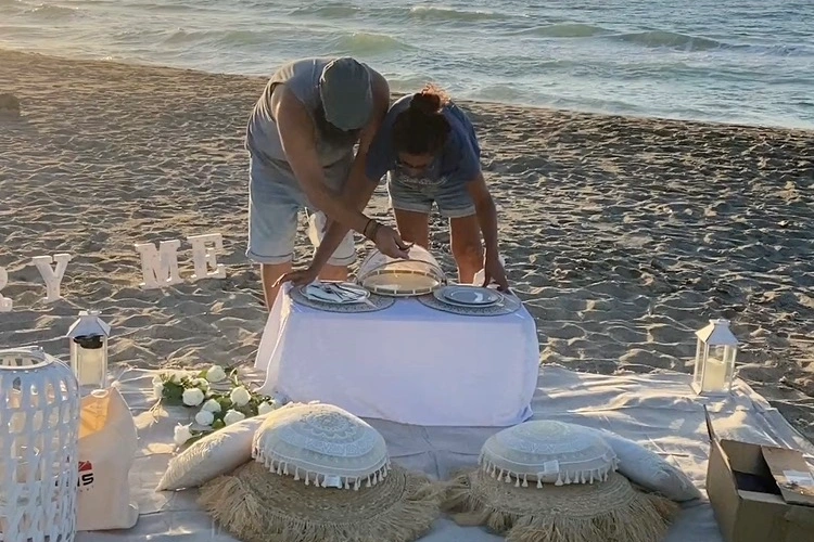 Propose4u team styling a luxury beach proposal setup at sunset