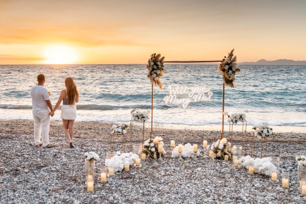 Luxury beach marriage proposal setup in Rhodes at sunset by the sea
