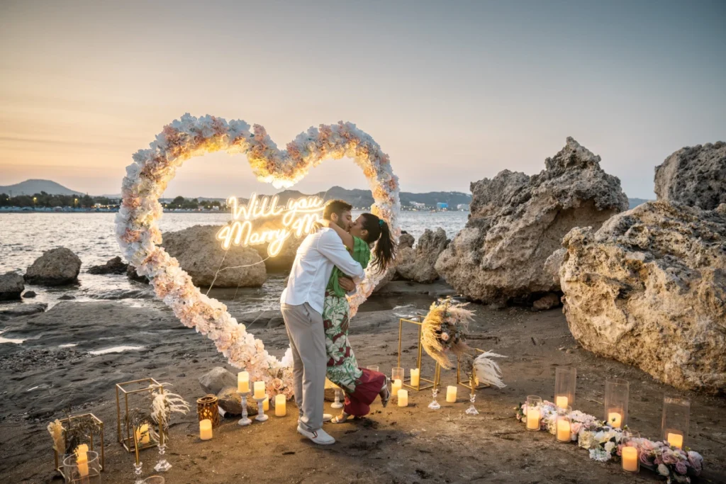 Couple celebrating a luxury beach marriage proposal in Rhodes at sunset