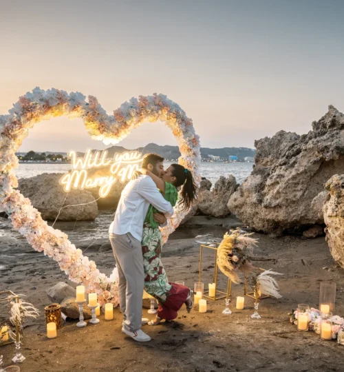 Couple celebrating a luxury beach marriage proposal in Rhodes at sunset